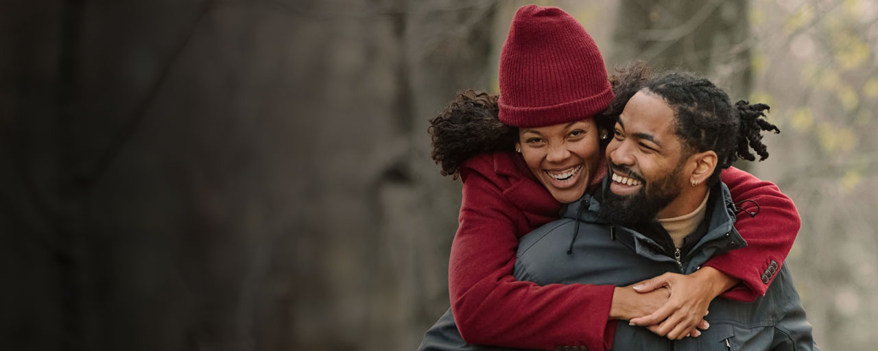 young couple hugging outside during winter.